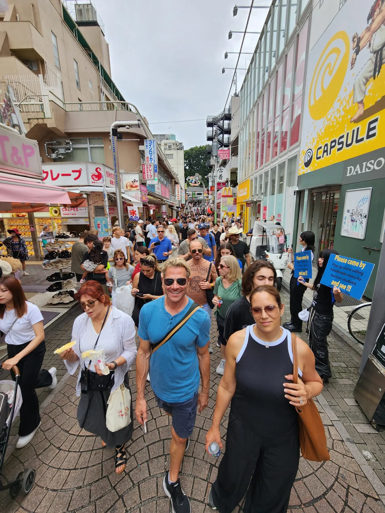 Tour guests walking along a busy shopping street