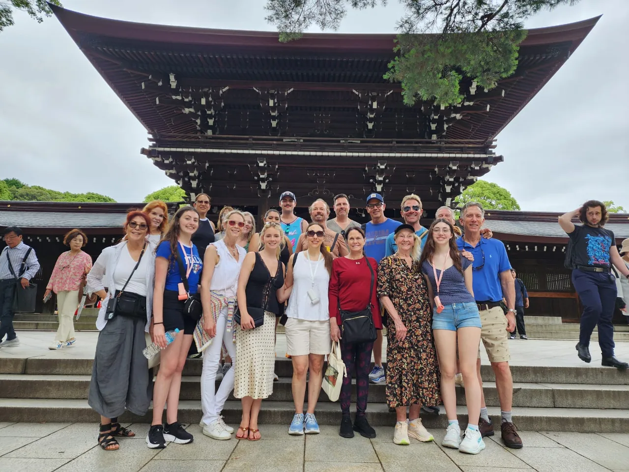 Tour guests standing in front of a large traditional gate